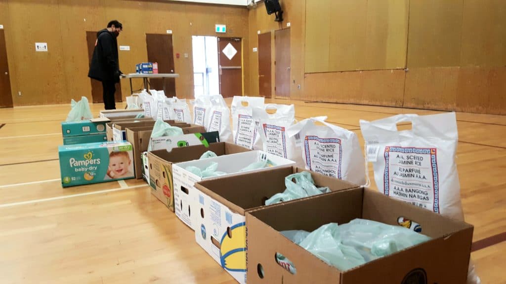 Food hampers with rice, mangoes, and other essentials